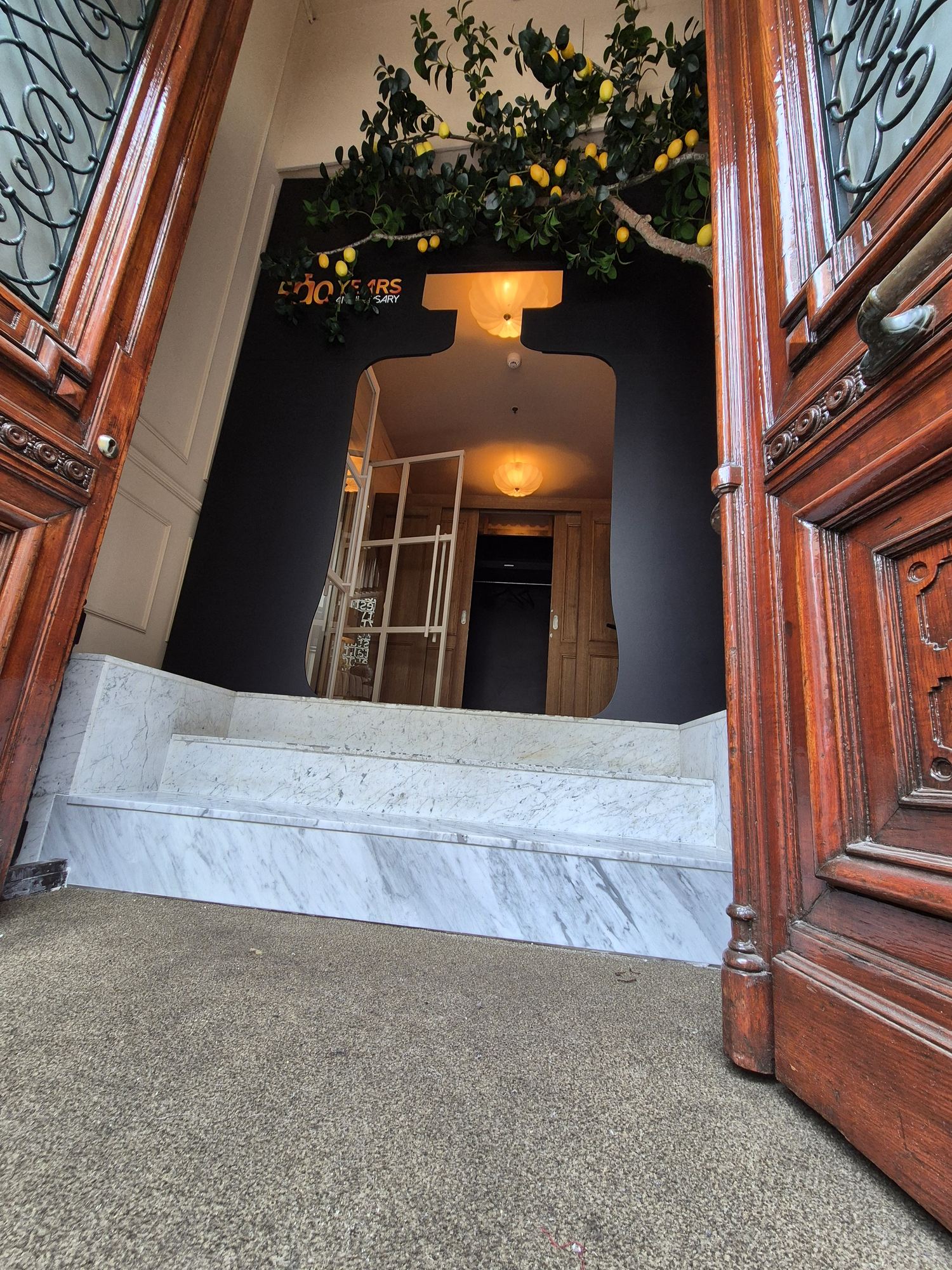 Low-angle detail of the Disaronno bottle entrance and surrounding historic doorway