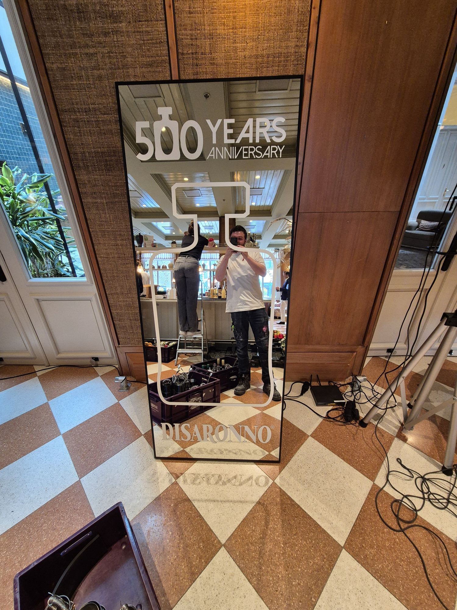 WAUD installing the branded Disaronno mirror on location