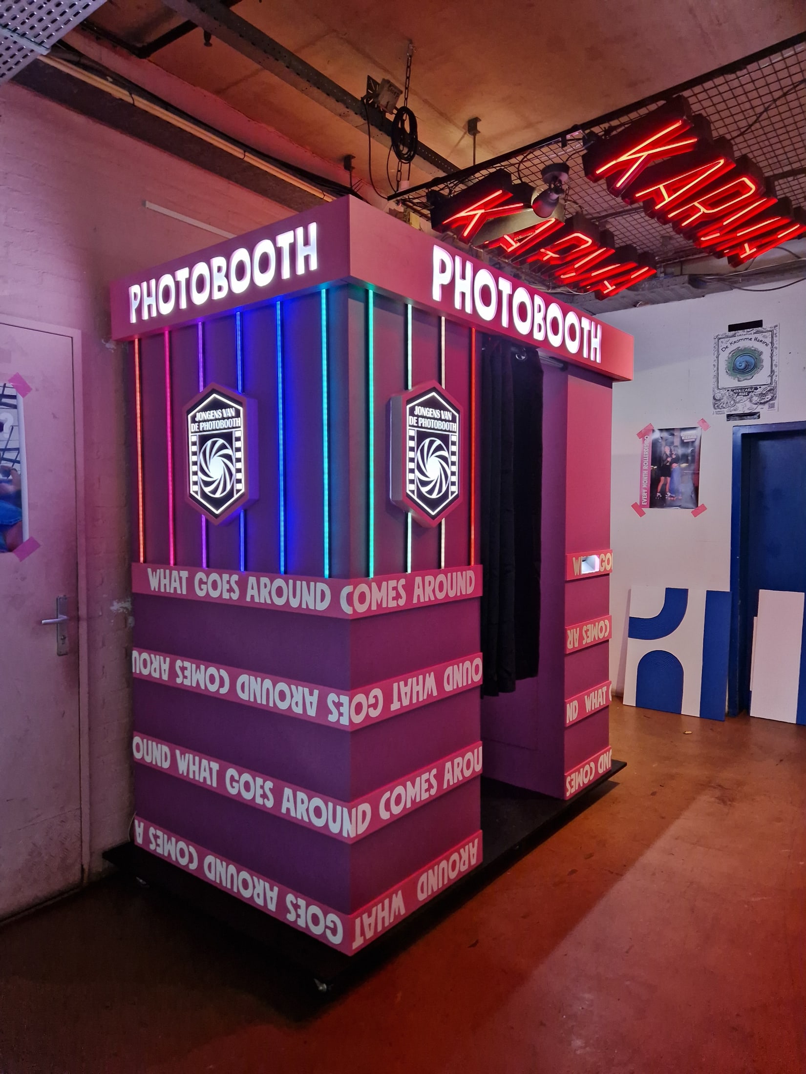 Front and side view showing the booth's integrated screens and lighting