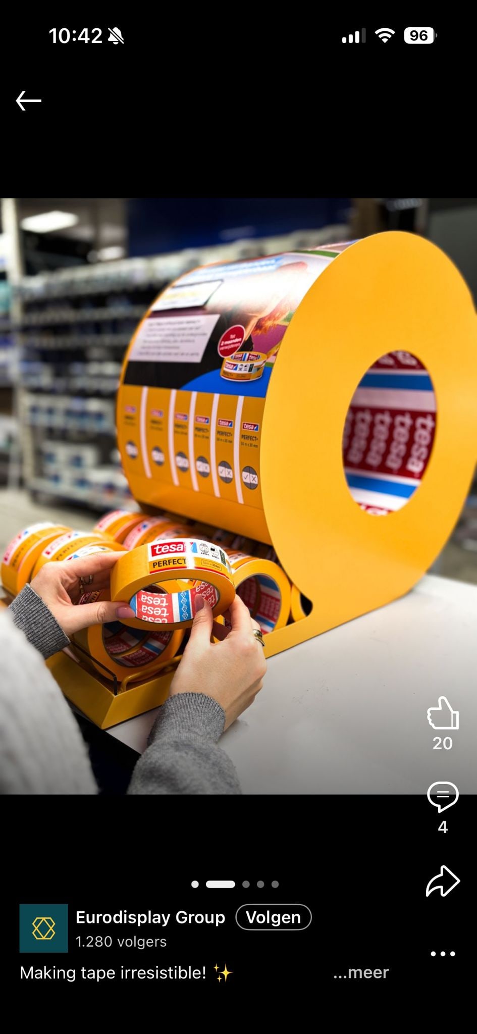 Customer taking a roll of Tesa tape from the retail display